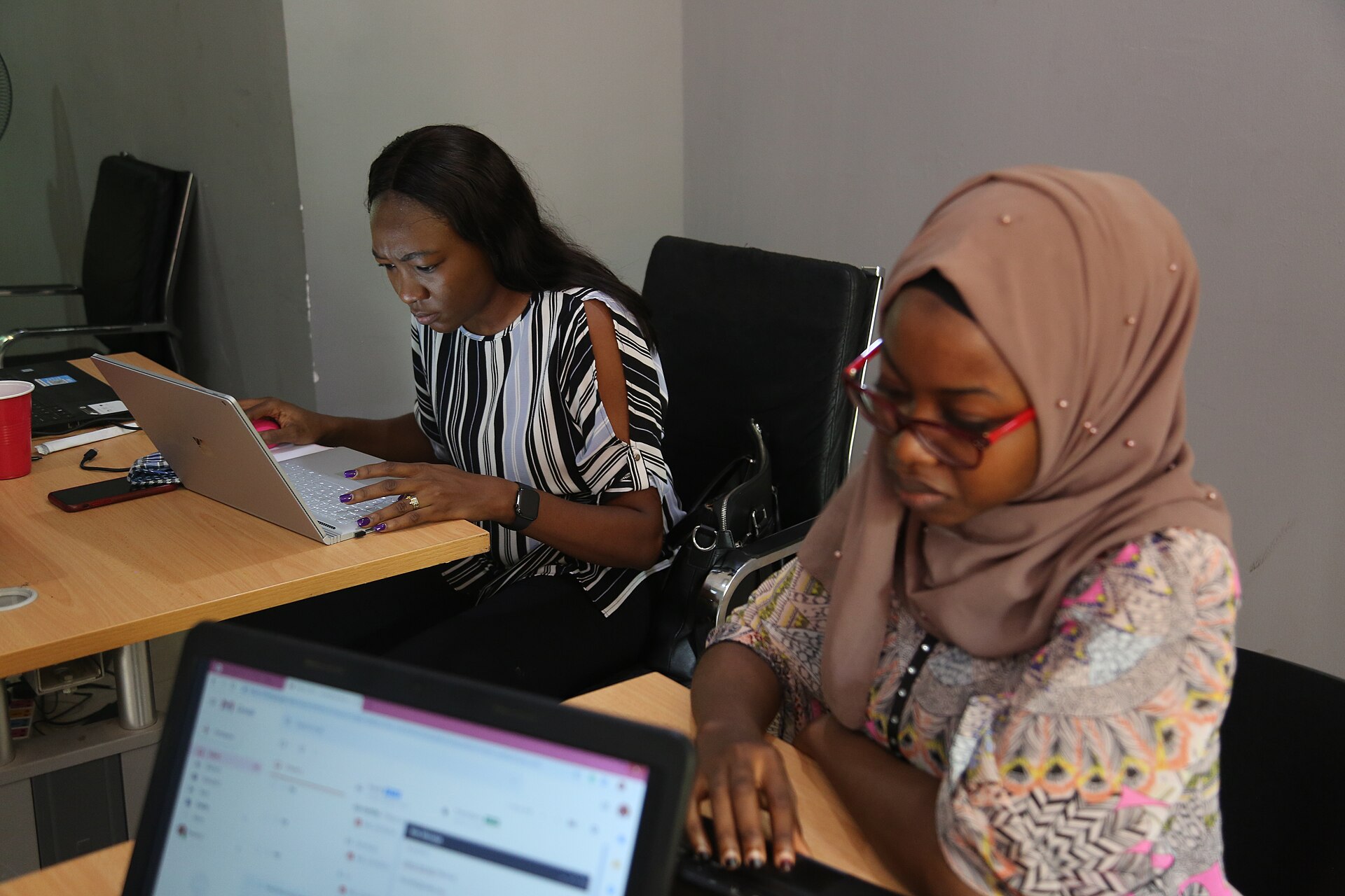Professionals working together on laptops